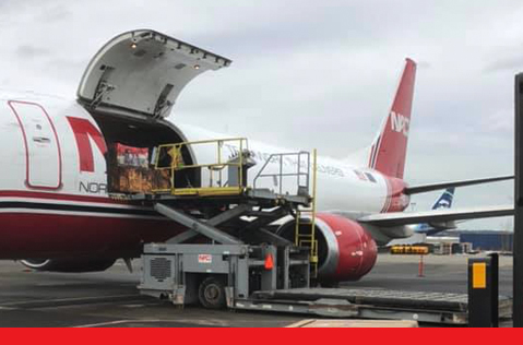 A Northern Air Cargo plane being loaded with freight. 