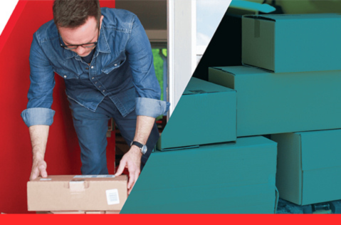 An employee sorting freight with a Northern Air Cargo plane in the background.